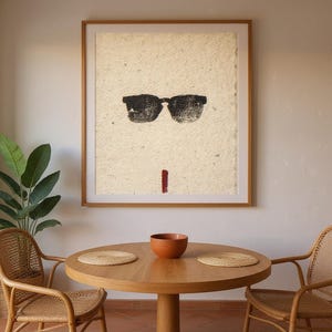 Sumi-e Wayfarer Sunglasses with Red Accent Print framed in a coastal dining room setting