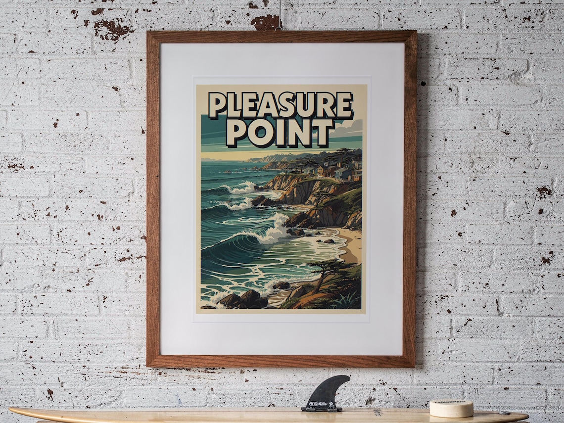 Pleasure Point Surf Travel Poster print in a Red Oak frame with a white mat, hanging above the workbench in a surf garage.