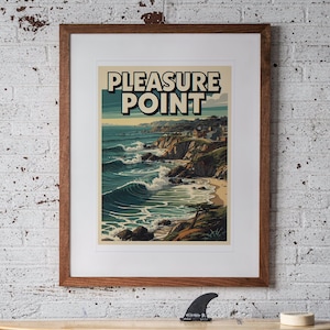 Pleasure Point Surf Travel Poster print in a Red Oak frame with a white mat, hanging above the workbench in a surf garage.