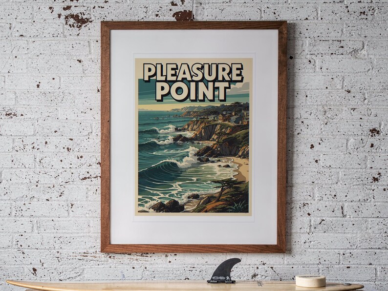 Pleasure Point Surf Travel Poster print in a Red Oak frame with a white mat, hanging above the workbench in a surf garage.