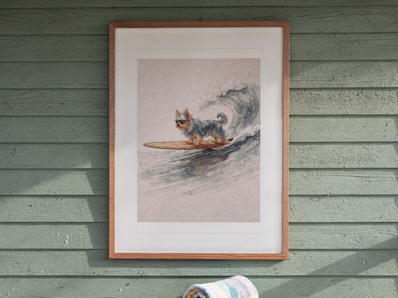 Yorkshire Terrier Surfing printable art, shown printed in a Red Oak frame with a white mat, hanging above the table in a screened beach porch.