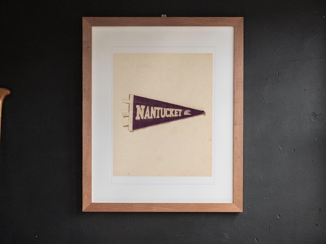 Nantucket print in a Red Oak frame with a white mat, hanging above the desk in a home office.