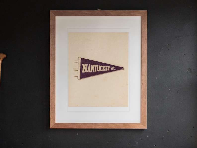 Nantucket print in a Red Oak frame with a white mat, hanging above the desk in a home office.