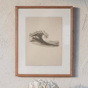 Wave Etching Style print in a Red Oak frame with a white mat, hanging above the table in a sunroom.