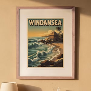 Windansea Surf Travel Poster print in a Red Oak frame with a white mat, hanging above the bedside table in a calm bedroom.