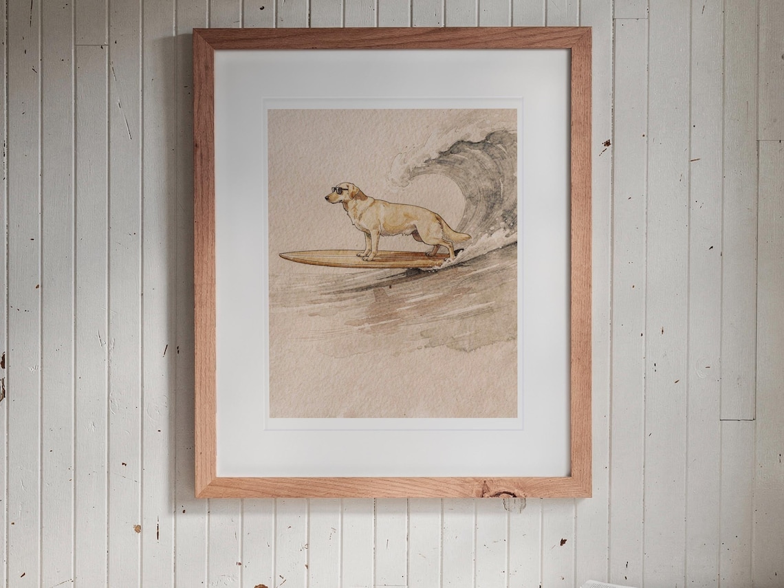Yellow Labrador Surfing print in a Red Oak frame with a white mat, hanging above the bench in a breakfast nook.