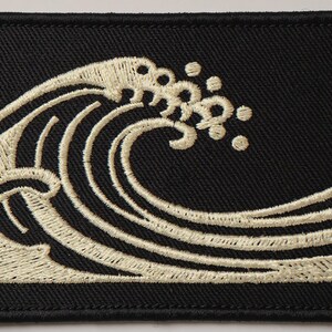Wave Embroidered Patch Print framed in a coastal dining room setting
