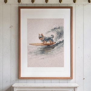 Yorkshire Terrier Surfing print in a Red Oak frame with a white mat, hanging above the bench in a beach cottage entryway.