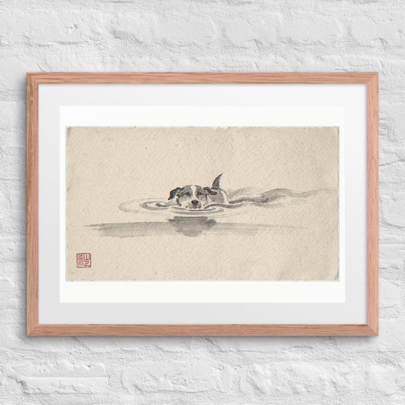 Swimming Dog Xieyi Ink print in a Red Oak 24 by 18 inch frame with a white mat on a white brick wall.