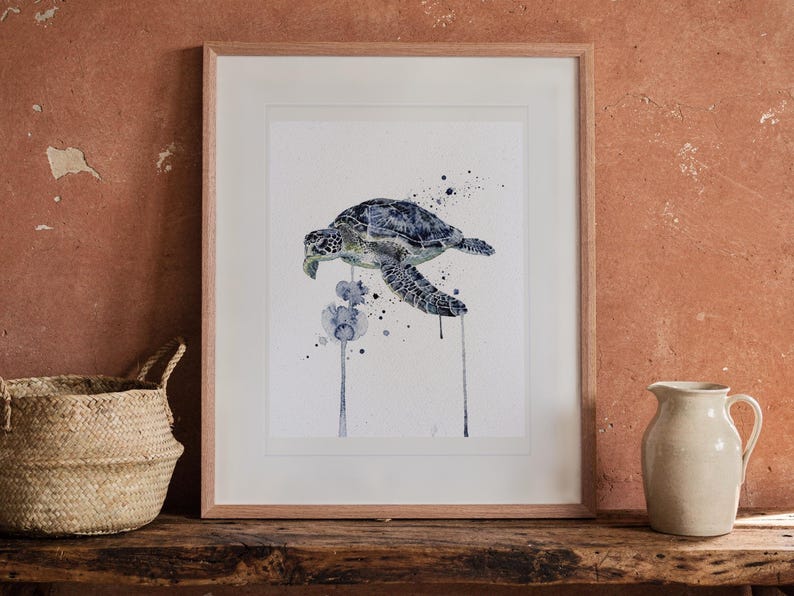 Sea Turtle Watercolor print in a Red Oak frame with a white mat, leaning on the bench against the wall in a boho living room.