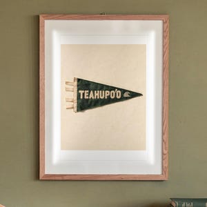 Teahupo'o Surf Pennant print in a Red Oak frame with a white mat, hanging above the sideboard in a mid-century living room.