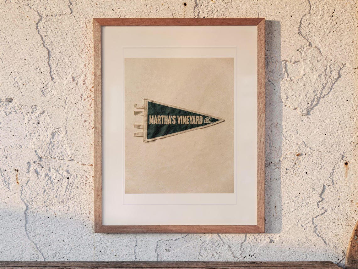 Martha's Vineyard Surf Pennant print in a Red Oak frame with a white mat, hanging above the bench in a beach house loft.