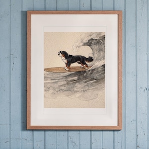 Bernese Mountain Dog Surfing print in a Red Oak frame with a white mat, hanging above the bench in a beach cottage entryway.