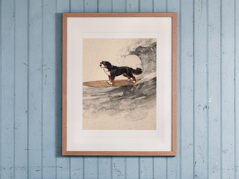 Bernese Mountain Dog Surfing print in a Red Oak frame with a white mat, hanging above the bench in a beach cottage entryway.