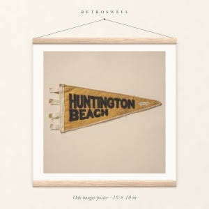 Huntington Beach Surf Pennant oak hanger poster, 18 by 18 inches, with natural wood rails and a hanging cord.
