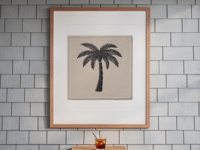 Palm Tree Patch print in a Red Oak frame with a white mat, hanging above the table in a screened beach porch.