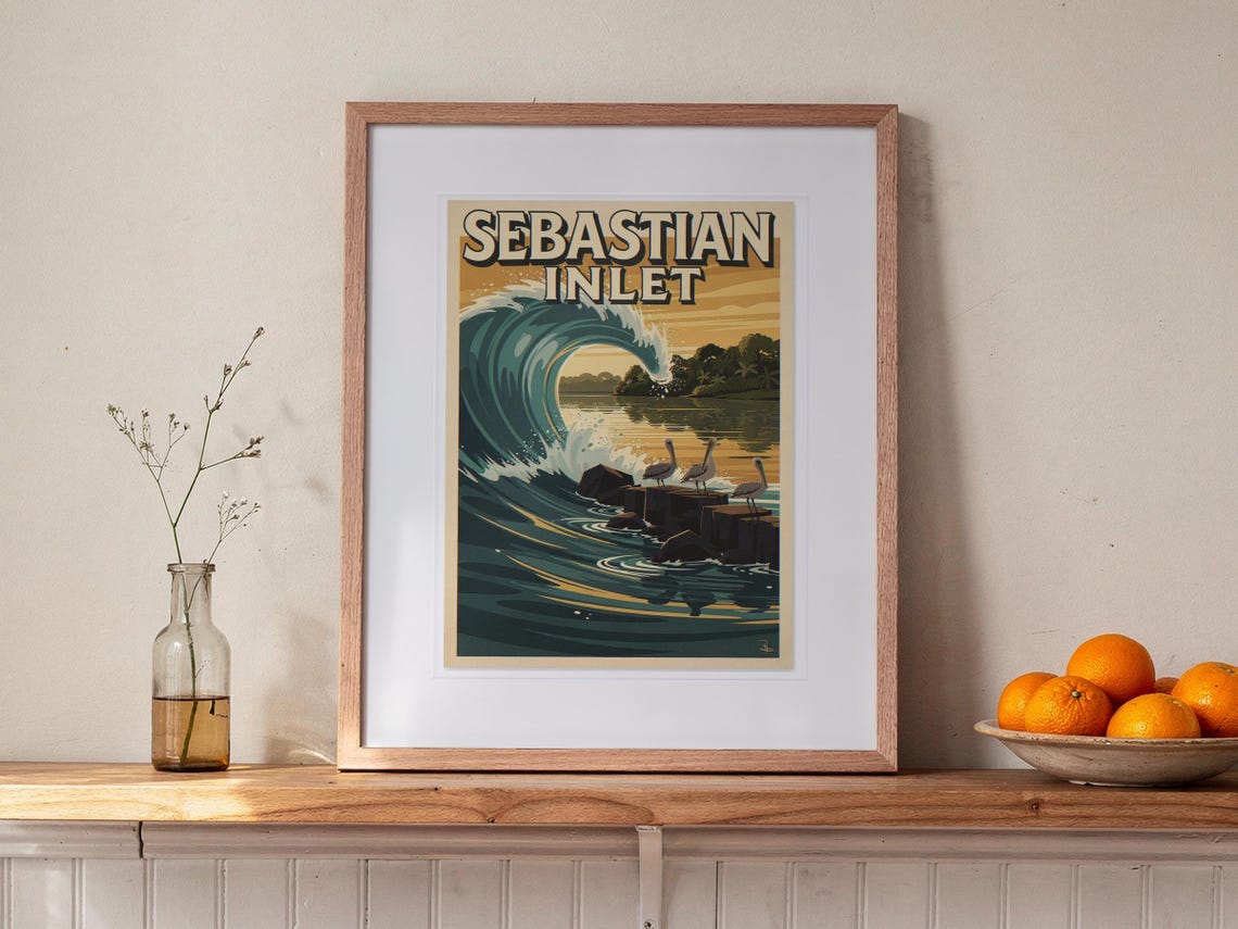 Sebastian Inlet Surf Travel Poster print in a Red Oak frame with a white mat, leaning on the ledge against the wall in a hallway.