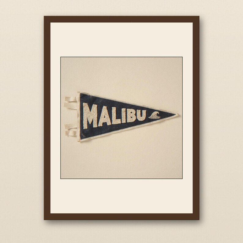 Malibu Vintage Surf Pennant Print - walnut framed art print with cream mat on plaster wall
