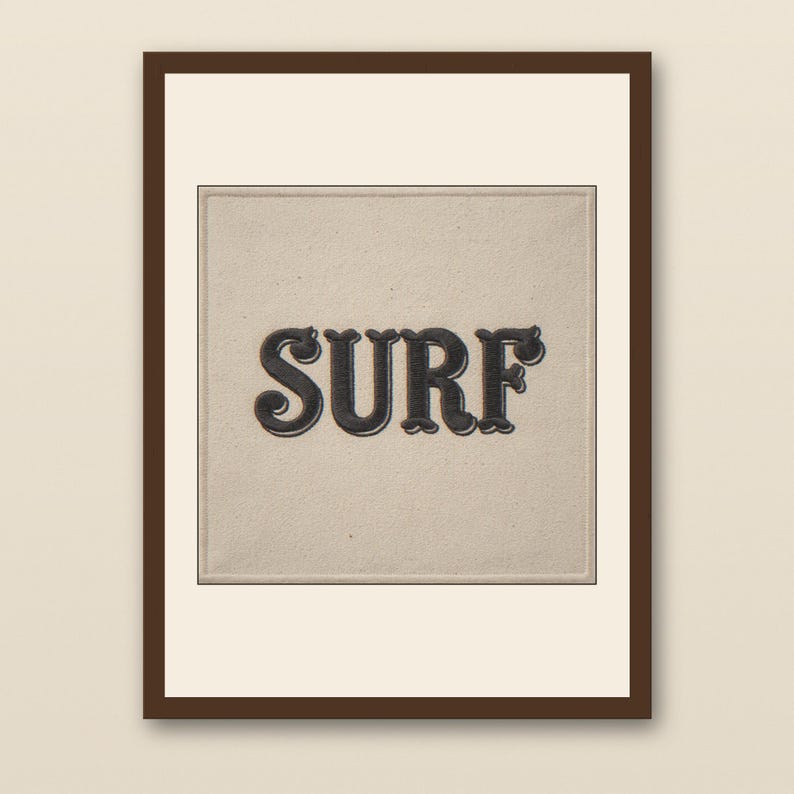 Surf Embroidered Patch Print - walnut framed art print with cream mat on plaster wall