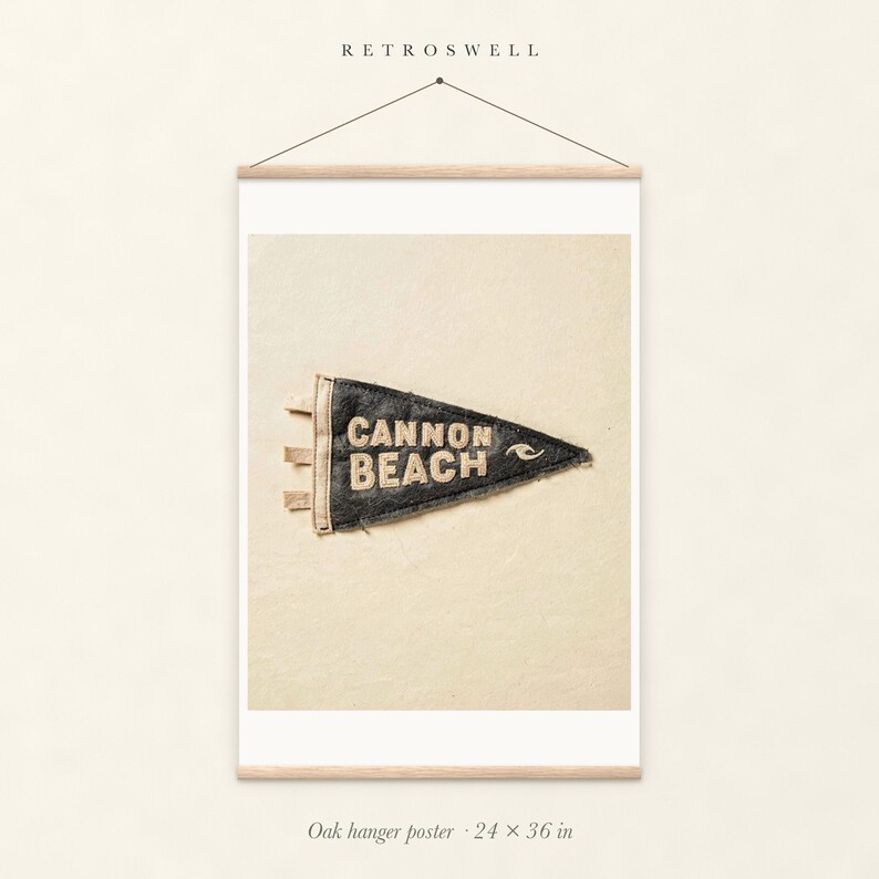 Cannon Beach, Oregon Surf Pennant oak hanger poster, 24 by 36 inches, with natural wood rails and a hanging cord.