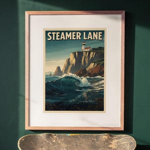 Steamer Lane Surf Travel Poster print in a Red Oak frame with a white mat, hanging above the desk in a green study.