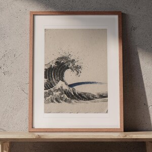 Crashing Wave Ink Style print in a Red Oak frame with a white mat, leaning on the bench against the wall in a japandi living room.