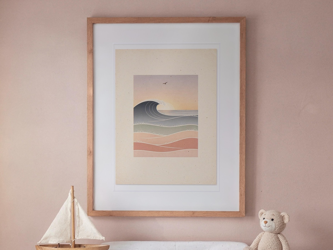 Pastel Morning Swells Nursery print in a Red Oak frame with a white mat, hanging above the dresser in a nursery.