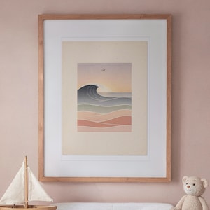 May include: A framed art print featuring a stylized ocean wave in shades of blue, green, and pink against a pale background. The artwork is enclosed in a light-toned wooden frame with a white mat, displaying a sunset scene with a small bird.