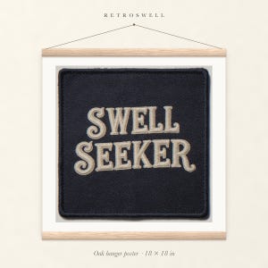 Swell Seeker Patch oak hanger poster, 18 by 18 inches, with natural wood rails and a hanging cord.