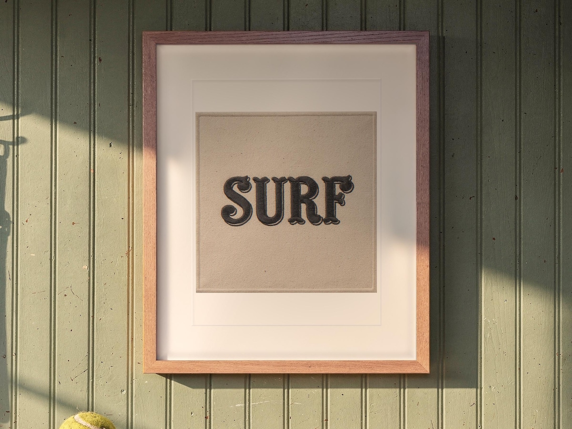 Surf Patch print in a Red Oak frame with a white mat, hanging above the bench in a mudroom.