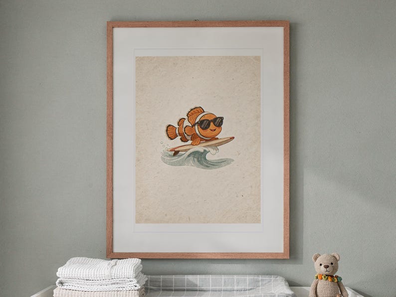 Surfing Clownfish print in a Red Oak frame with a white mat, hanging above the dresser in a nursery.
