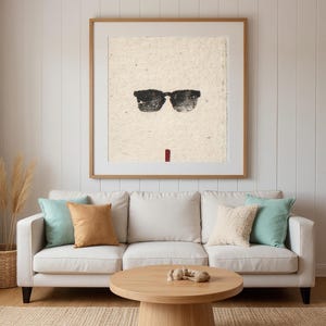 Sumi-e Wayfarer Sunglasses with Red Accent Print framed in a beach-style living room setting