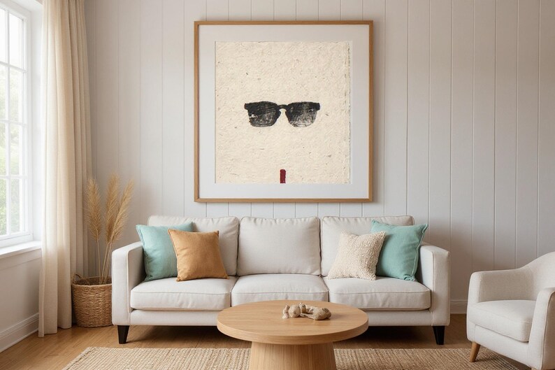 Sumi-e Wayfarer Sunglasses with Red Accent Print framed in a beach-style living room setting
