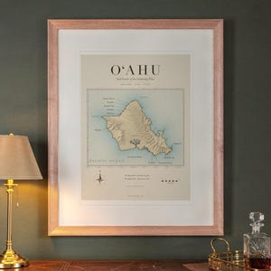 Oahu Surf Map print in a Red Oak frame with a white mat, hanging above the desk in a green study.