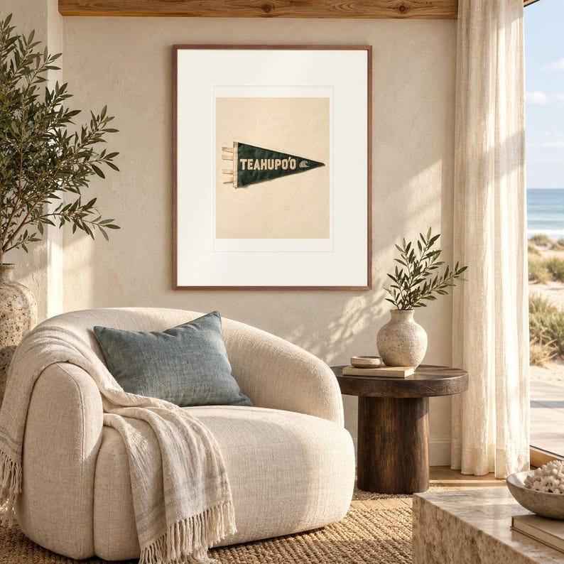 Teahupo'o Surf Pennant print in a Red Oak frame with a white mat in a light-filled coastal sitting room.