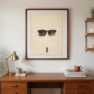 Sumi-e Wayfarer Sunglasses with Red Accent Print framed in a home office setting