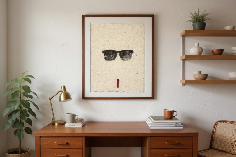 Sumi-e Wayfarer Sunglasses with Red Accent Print framed in a home office setting