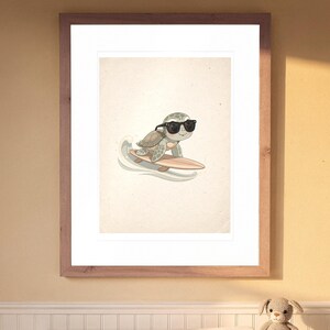 Surfing Sea Turtle print in a Red Oak frame with a white mat, hanging above the dresser in a nursery.