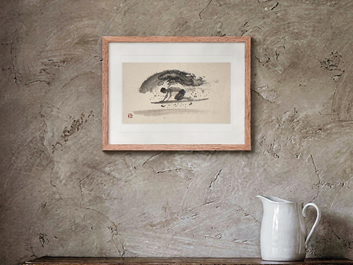 Surfer Duck Dive Xieyi Ink print in a Red Oak frame with a white mat, hanging above the buffet in a dining room.