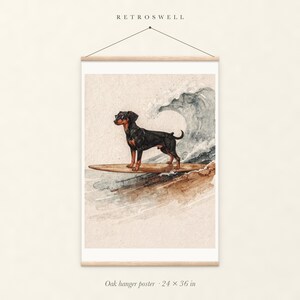 Doberman Surfing oak hanger poster, 24 by 36 inches, with natural wood rails and a hanging cord.