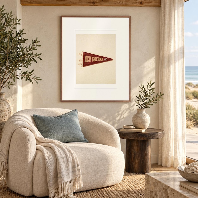 New Smyrna Beach Surf Pennant print in a Red Oak frame with a white mat in a light-filled coastal sitting room.