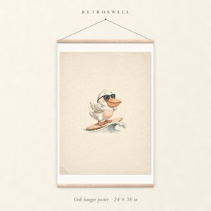 Pelican Surfing oak hanger poster, 24 by 36 inches, with natural wood rails and a hanging cord.