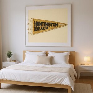 Huntington Beach Vintage Surf Pennant Print framed in a modern bedroom setting
