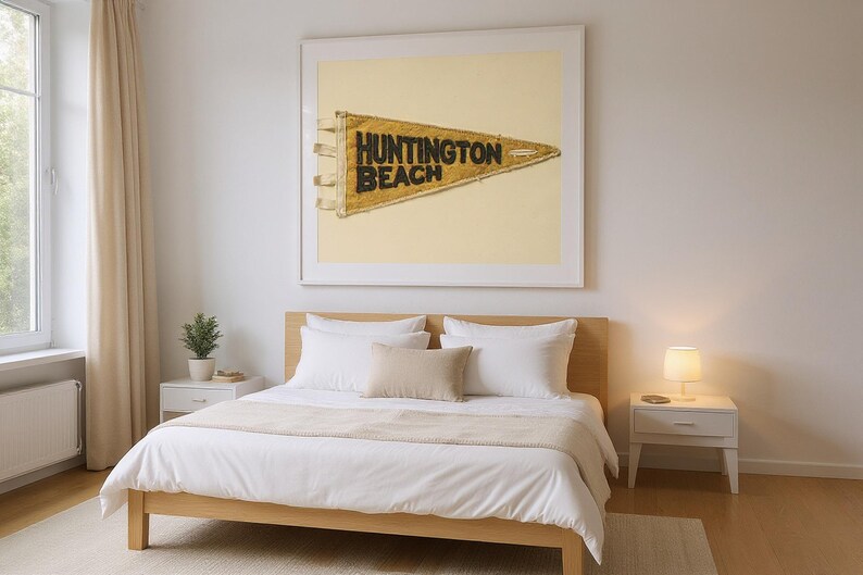 Huntington Beach Vintage Surf Pennant Print framed in a modern bedroom setting
