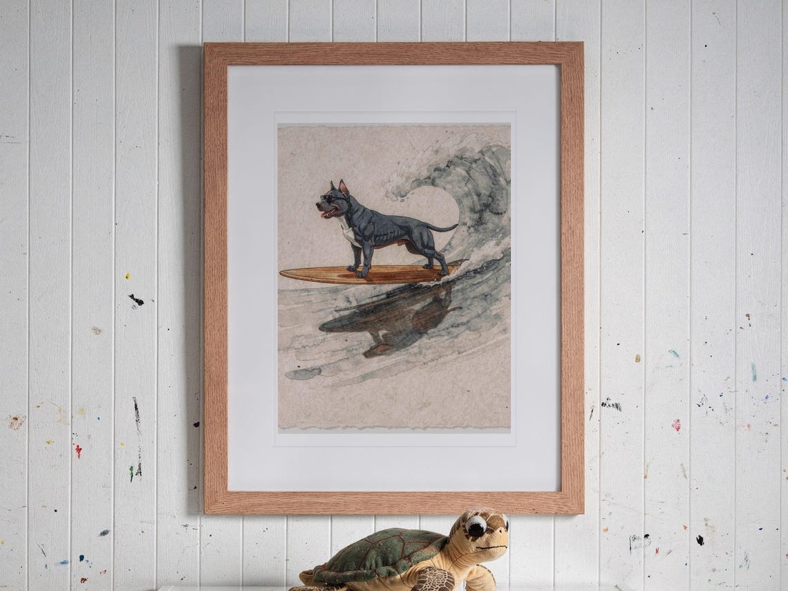 Pit Bull Surfing print in a Red Oak frame with a white mat, hanging above the bookshelf in a kids' room.