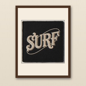 Surf Embroidered Patch Print - walnut framed art print with cream mat on plaster wall