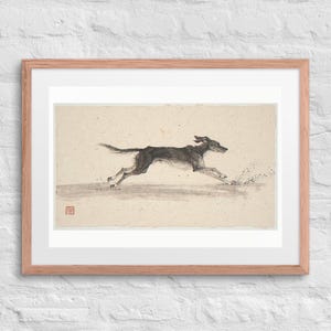 Dog Running on the Beach Xieyi Ink print in a Red Oak 24 by 18 inch frame with a white mat on a white brick wall.