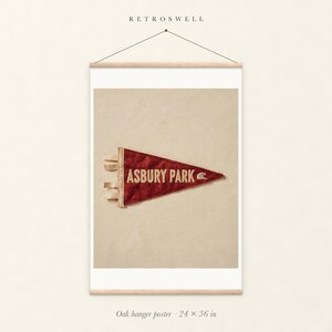 Asbury Park Surf Pennant oak hanger poster, 24 by 36 inches, with natural wood rails and a hanging cord.