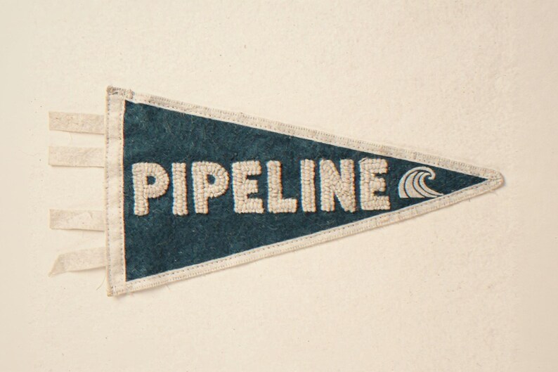 Pipeline Vintage Surf Pennant Print framed in a beach-style living room setting