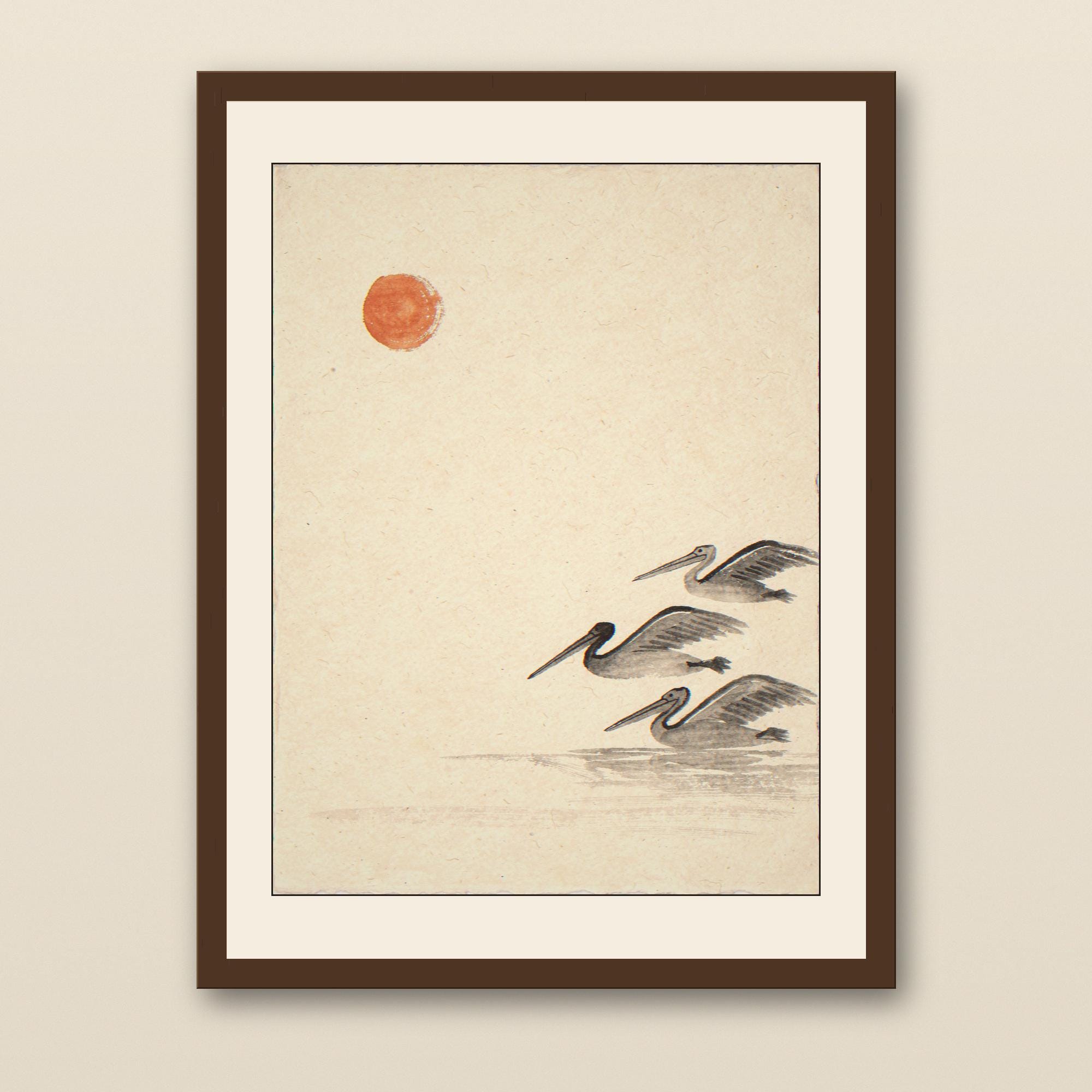 Sumi-e Three Pelicans with Persimmon Accent Print - walnut framed art print with cream mat on plaster wall